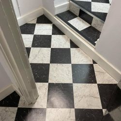 Chess style vinyl flooring installed in an apartment stairway in Consett