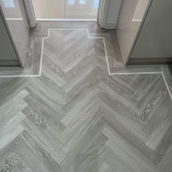Light grey herringbone flooring with a double border fitted in a kitchen in Consett