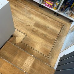 Steps into a home pantry fitted with wood effect LVT Flooring