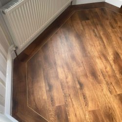 Dark wood LVT Flooring with a border fitted in a lounge in Consett