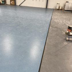 Blue and grey safety flooring installed in a warehouse in Consett
